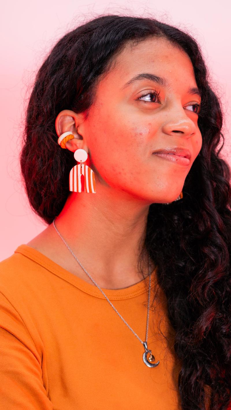 Model wearing handmade Ema&Clay arch earrings